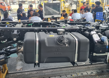 Cobot for fuel tank fitment in a vehicle assembly line