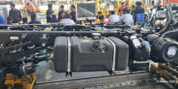 Cobot for fuel tank fitment in a vehicle assembly line